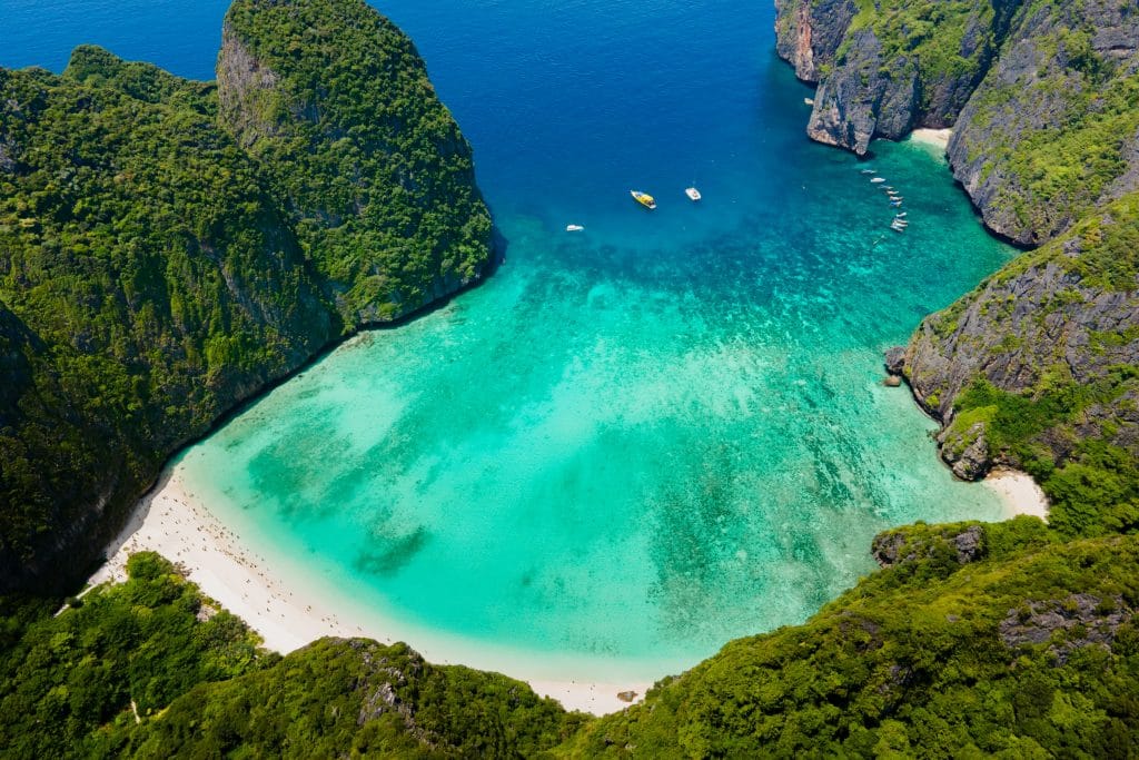 Aerial view of Maya Bay on Phi Phi Leh with its curved white beach, turquoise water and limestone cliffs